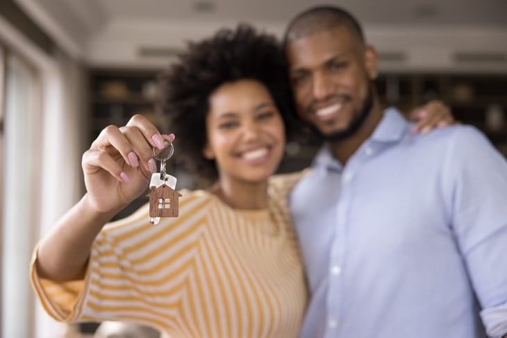 Happy couple with house keys