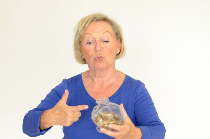 Senior woman with a jar of coins