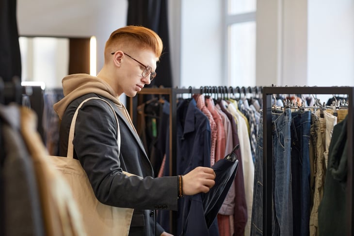 Shopper buying clothes at a thrift store