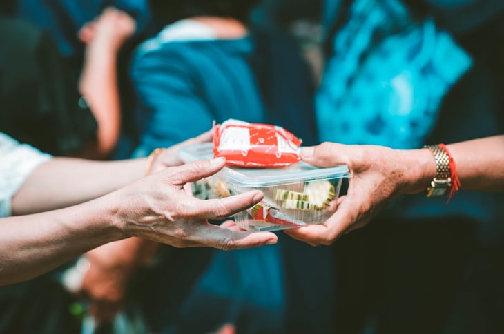 handing food container to someone