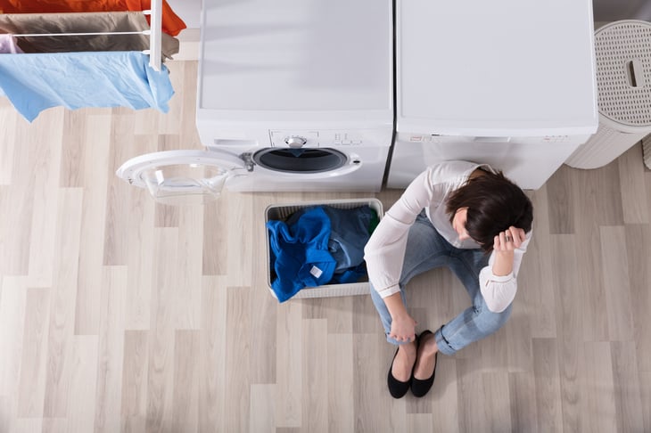 Upset woman in a laundry room