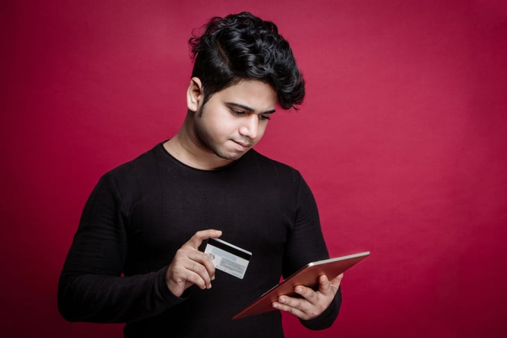 Unhappy millennial man shopping online