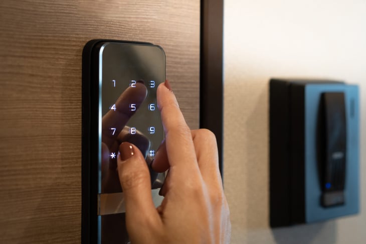 entering passcode on a smart digital touch screen keypad entry door lock