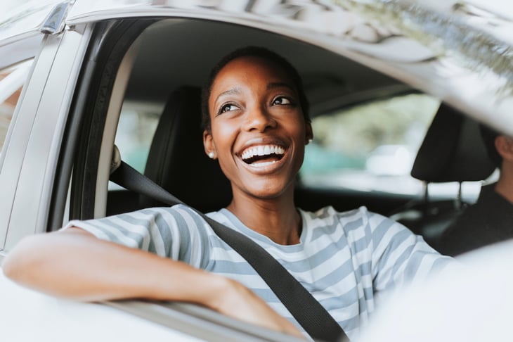 Happy woman in car