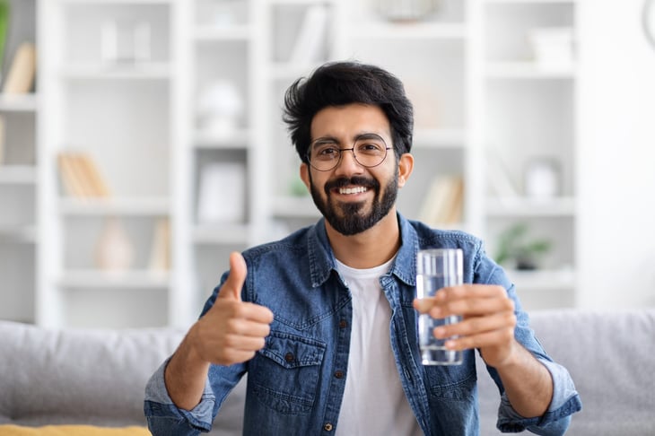 Happy man drinking water