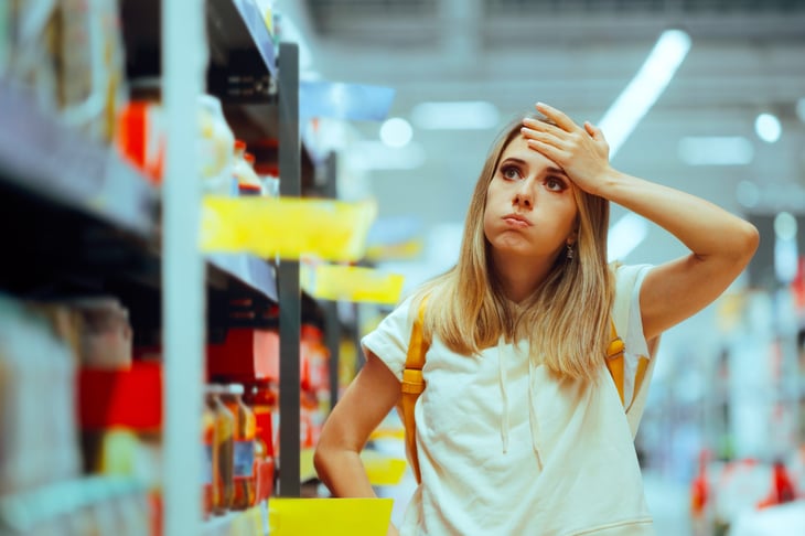 Unhappy woman shopping in a grocery or dollar store
