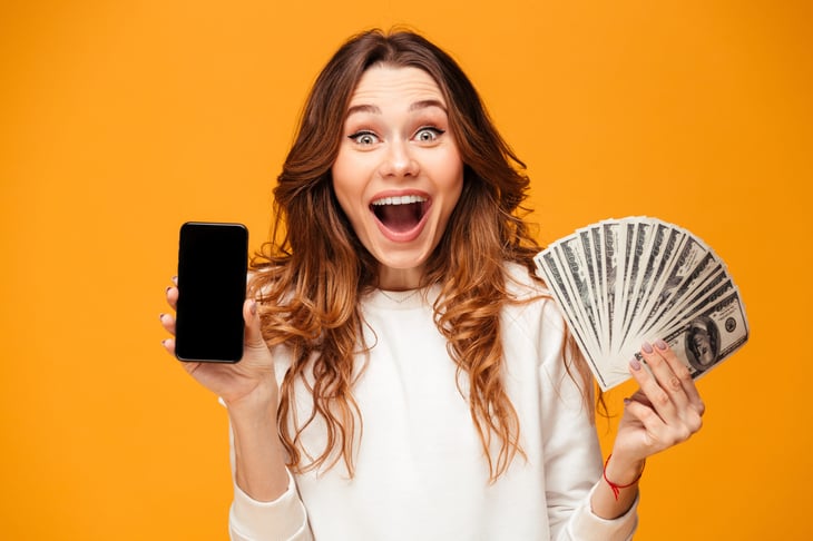 Woman with money and phone