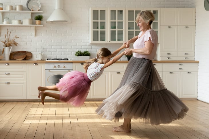 Woman with a child dancing in a kitchen