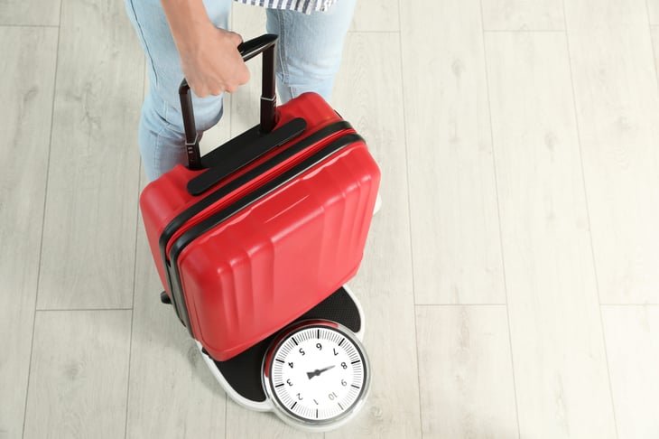 Luggage bag being weighed on a scale
