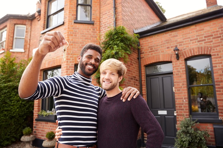 Excited couple with the keys to their new home