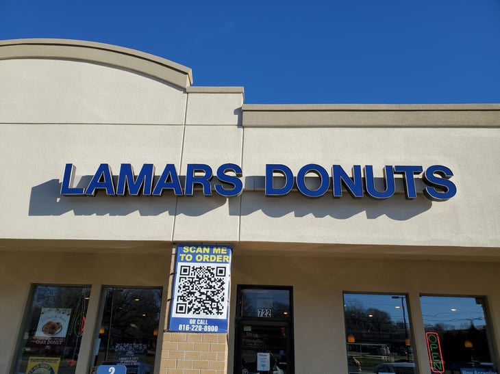 Sign above the entrance for LAMAR'S DONUTS