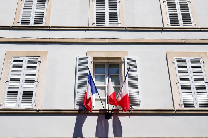 Red, white, and blue French flag in France on a building