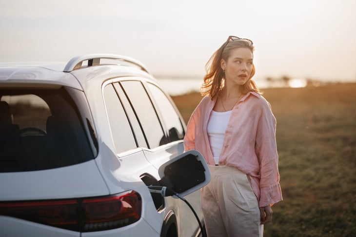 Woman charging her electric vehicle