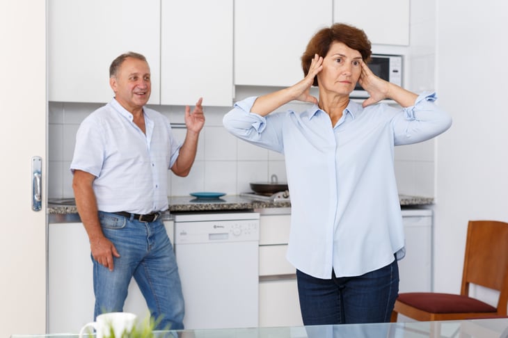 Upset woman in the kitchen with man
