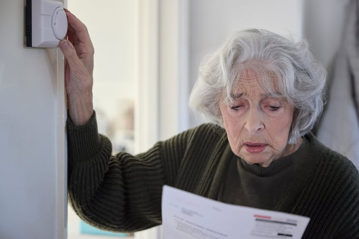 Worried senior woman looking at a bill