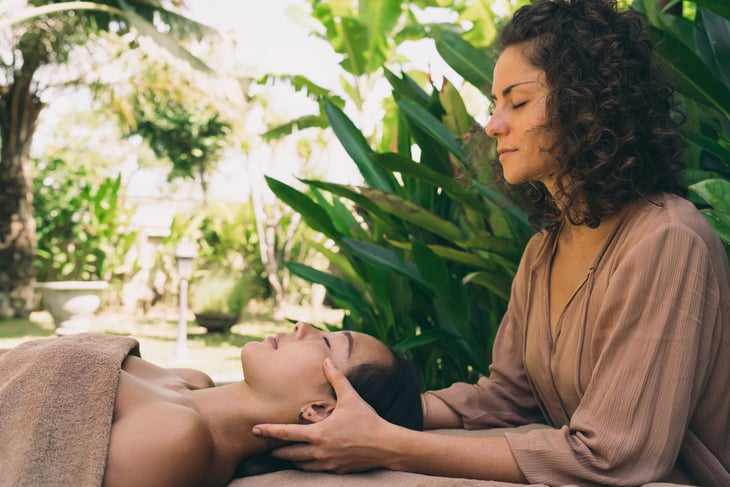 Woman getting a massage outside at a day spa