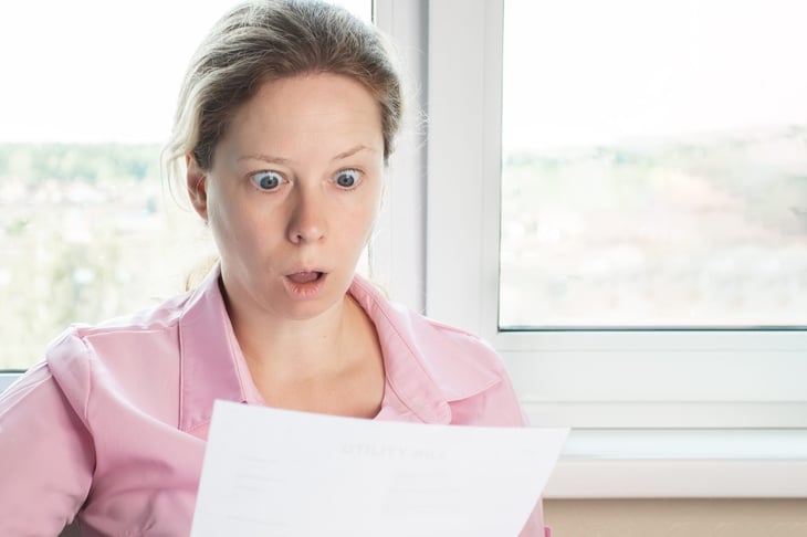 Unhappy woman looking at her tax return