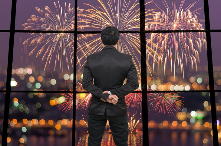Businessman watching fireworks on the 4th of July celebrating financial independence