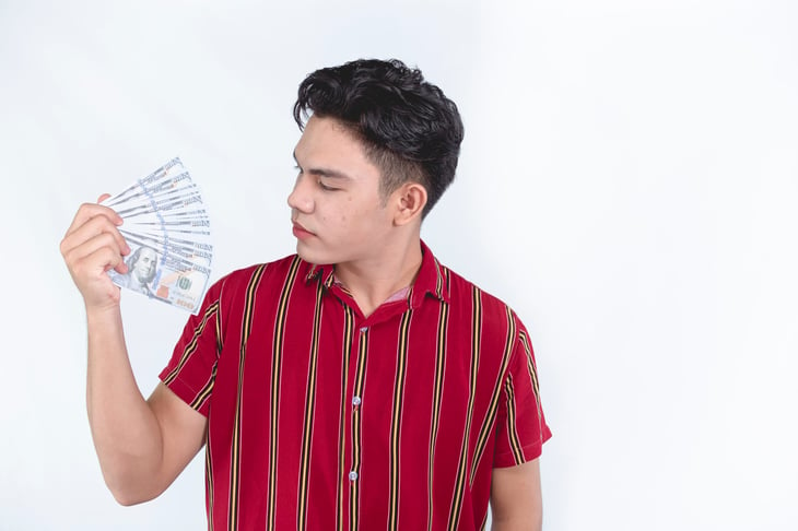 Man fanning himself with money