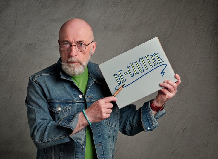 man with a declutter sign