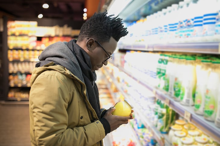 Man looking at food label in the grocery store.