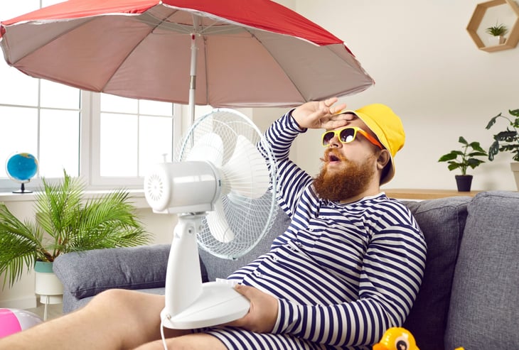 man sweltering in heat desperate to stay cool