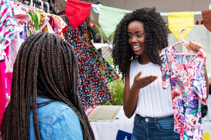 flea market vendor showing clothes