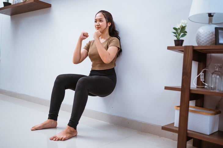 Woman doing a wall squat