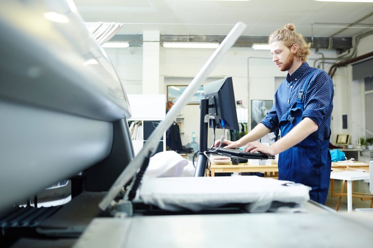 Man using printer at a self-service printing store