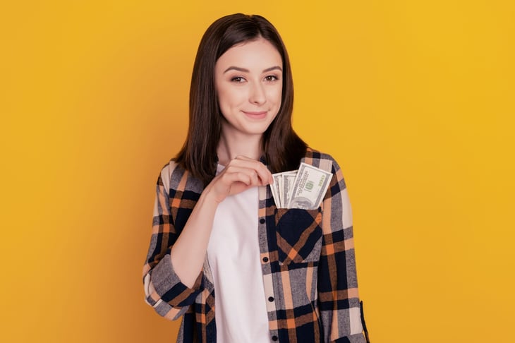 Woman with money in her pocket
