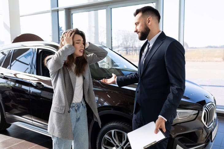 Upset woman a car dealership