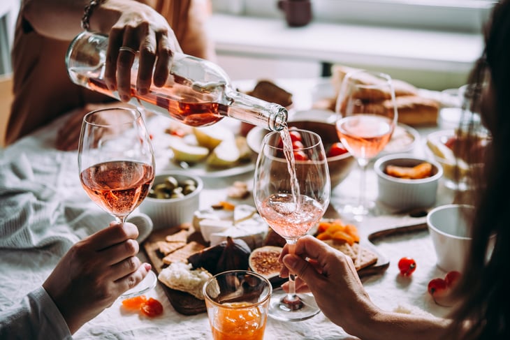 Pouring wine at a dinner party