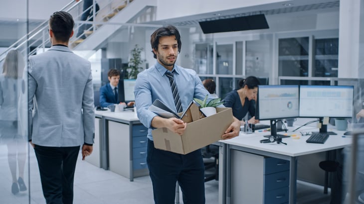 Laid off office worker carrying box