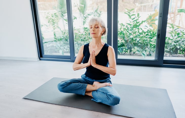 Calm older woman meditating