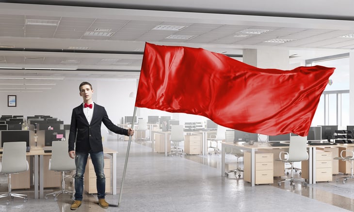 Man waving red flag