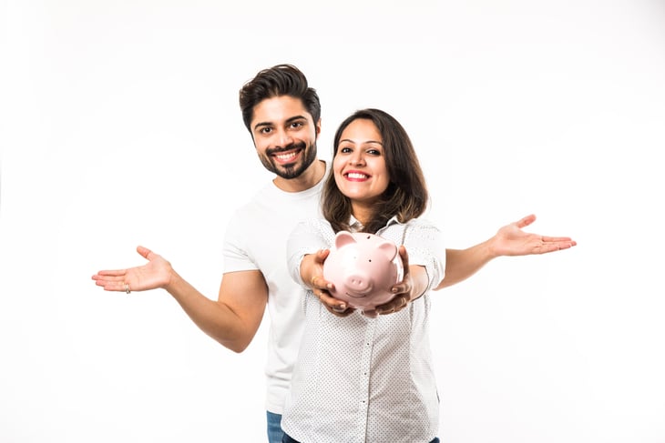 happy couple with piggy bank