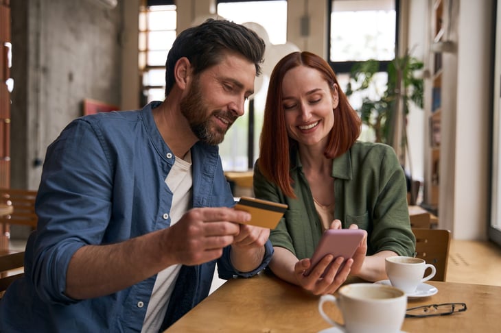 couple with credit card and phone