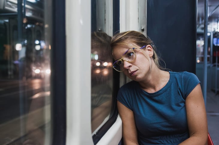 unhappy sad frustrated woman on train or bus