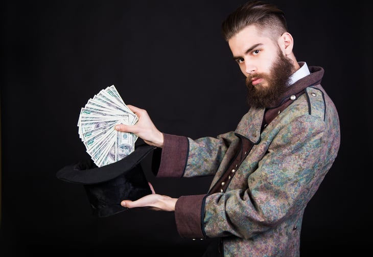 Magician pulling money out of hat