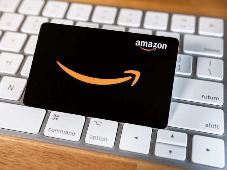 Amazon gift card with a smile logo sitting on a keyboard