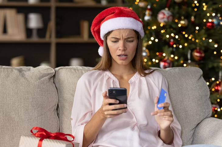 Woman with Santa Hat and Phone