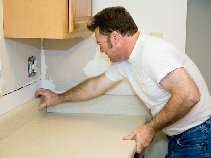 Contractor installing laminate countertop