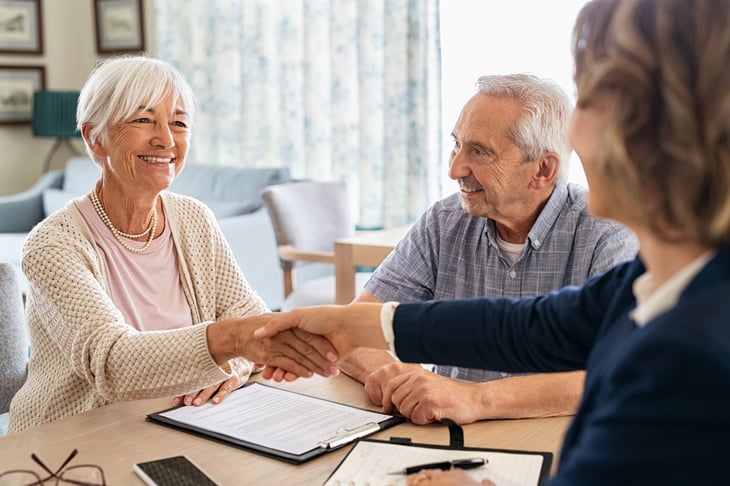 older couple shaking hands medicare insurance loan