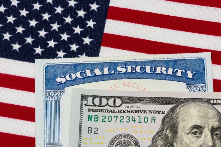 American flag with Social Security card and $100 bill, depicting average Social Security benefits