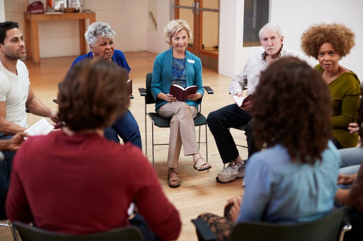 People sitting in a circle for a book club discussion