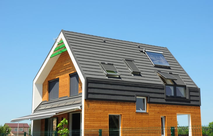 Modern Passive House Exterior. Modern energy efficient house with skylight windows and solar panels