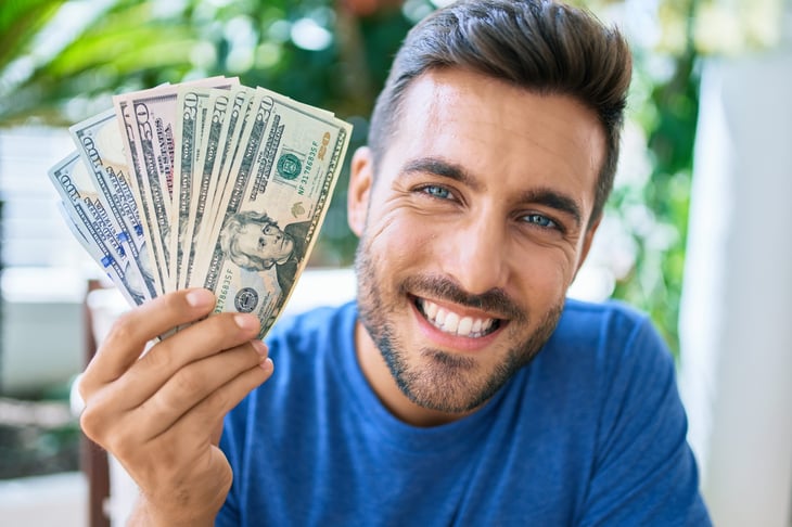Happy man holding money