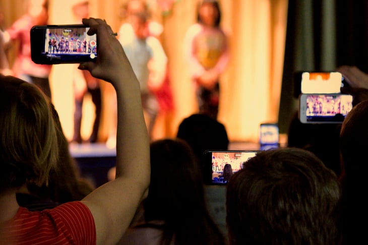 parents with cell phones during school play