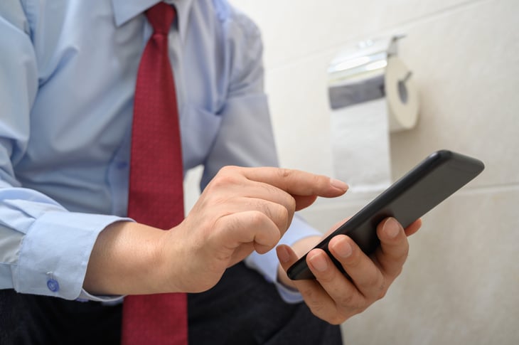 Man on phone in bathroom