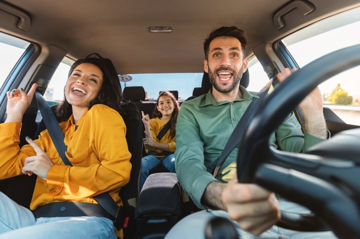 Happy family driving in a car